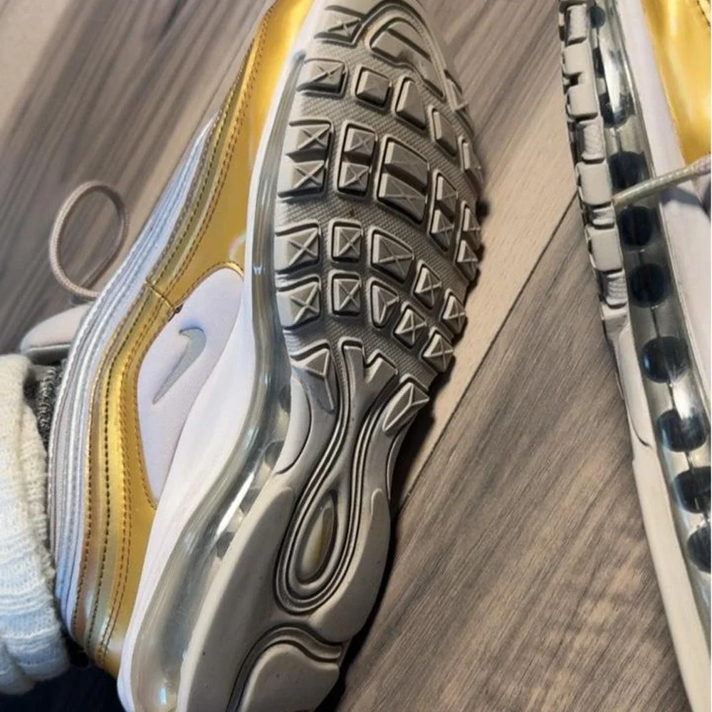 Nike Air Max 97 sneakers in gold and white with silver accents